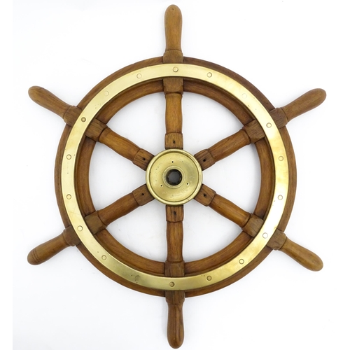 1245 - Nautical / Maritime Interest: A 20thC hardwood ship's wheel with six spokes and brass mounts. Approx... 