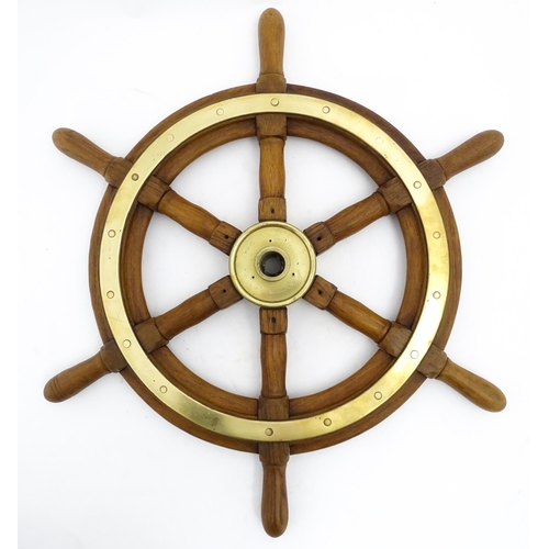 1245 - Nautical / Maritime Interest: A 20thC hardwood ship's wheel with six spokes and brass mounts. Approx... 