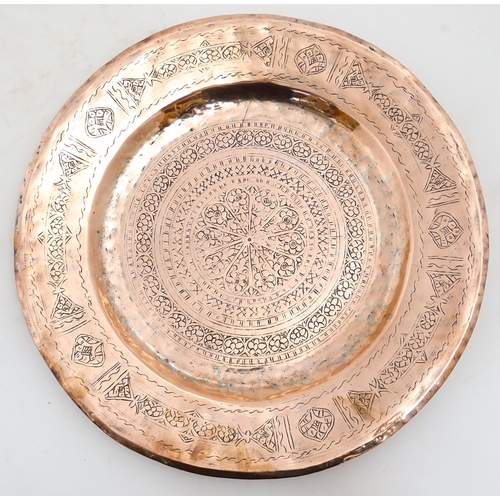 1250 - An Indian copper charger decorated with central floral motif and bordered by bands of flowers. Appro... 