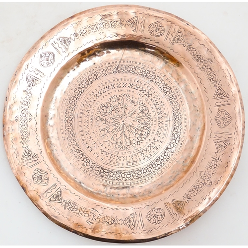 1250 - An Indian copper charger decorated with central floral motif and bordered by bands of flowers. Appro... 