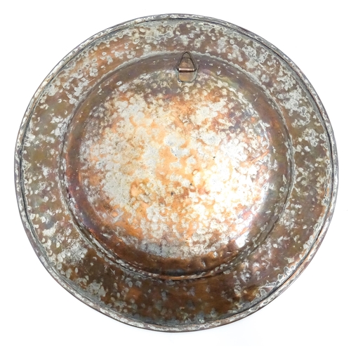 1250 - An Indian copper charger decorated with central floral motif and bordered by bands of flowers. Appro... 