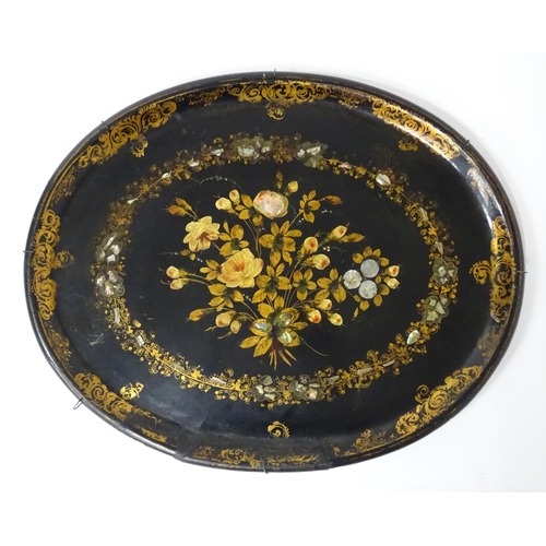 1251 - A Victorian papier mache tray of oval form decorated with gilt floral decoration and inlaid abalone ... 