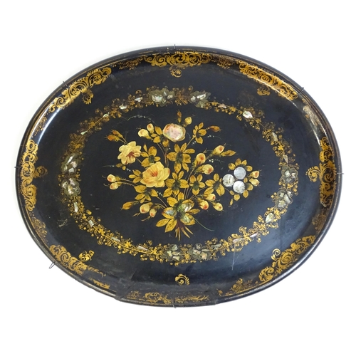 1251 - A Victorian papier mache tray of oval form decorated with gilt floral decoration and inlaid abalone ... 