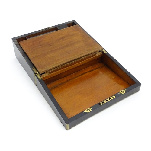 1254 - A 19thC coromandel writing slope with brass mounts, opening to reveal a fitted interior. Approx. 6