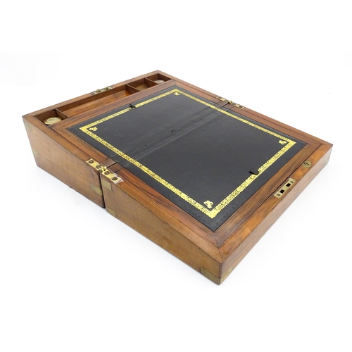 1256 - A Victorian walnut writing slope with brass mounts, the escutcheon dated 1898, opening to reveal a f... 