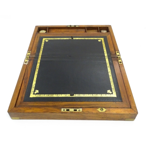 1256 - A Victorian walnut writing slope with brass mounts, the escutcheon dated 1898, opening to reveal a f... 