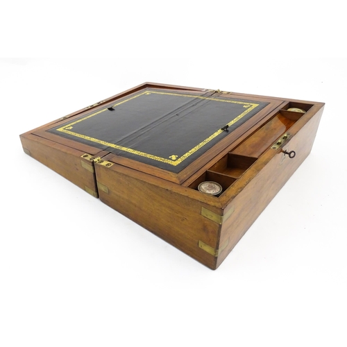 1256 - A Victorian walnut writing slope with brass mounts, the escutcheon dated 1898, opening to reveal a f... 