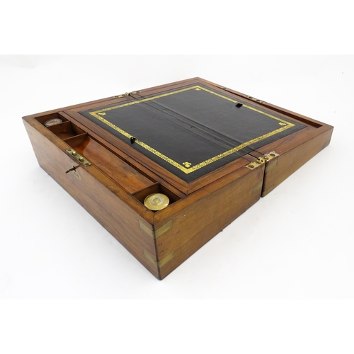 1256 - A Victorian walnut writing slope with brass mounts, the escutcheon dated 1898, opening to reveal a f... 