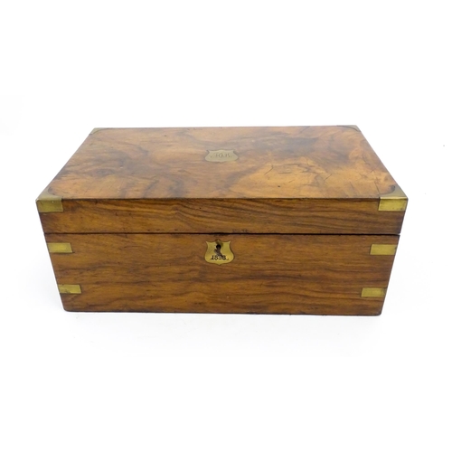 1256 - A Victorian walnut writing slope with brass mounts, the escutcheon dated 1898, opening to reveal a f... 