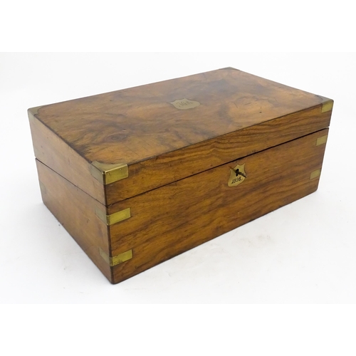 1256 - A Victorian walnut writing slope with brass mounts, the escutcheon dated 1898, opening to reveal a f... 