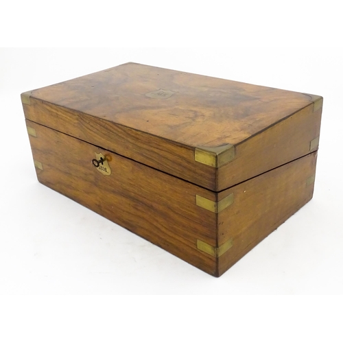 1256 - A Victorian walnut writing slope with brass mounts, the escutcheon dated 1898, opening to reveal a f... 