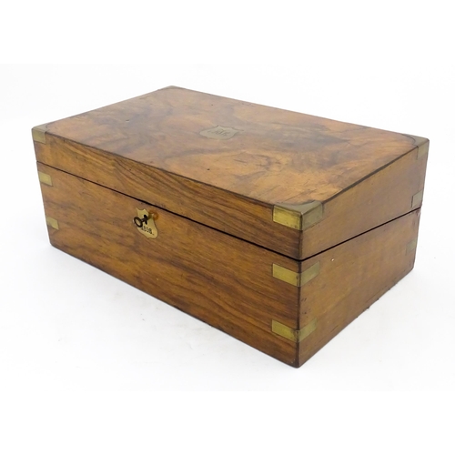 1256 - A Victorian walnut writing slope with brass mounts, the escutcheon dated 1898, opening to reveal a f... 