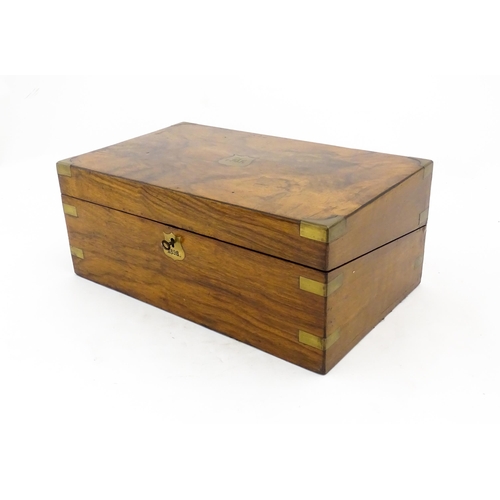 1256 - A Victorian walnut writing slope with brass mounts, the escutcheon dated 1898, opening to reveal a f... 