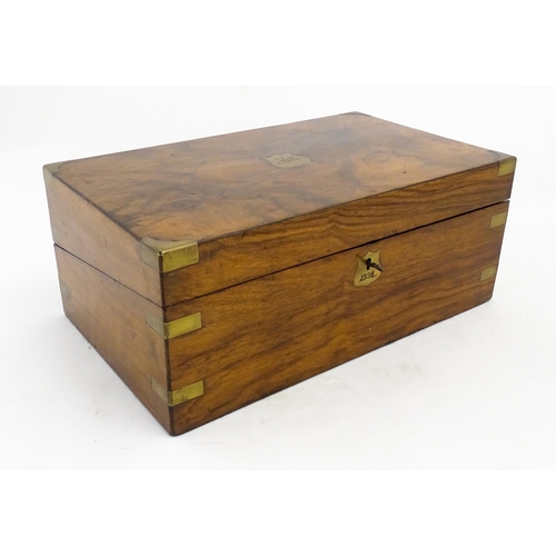 1256 - A Victorian walnut writing slope with brass mounts, the escutcheon dated 1898, opening to reveal a f... 