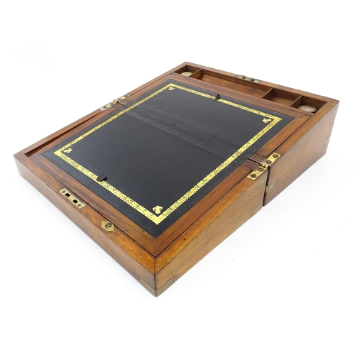 1256 - A Victorian walnut writing slope with brass mounts, the escutcheon dated 1898, opening to reveal a f... 