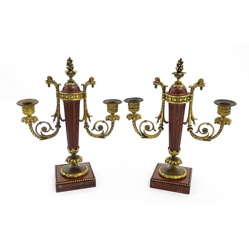 1264 - A pair of Continental 19thC marble and gilt metal twin branch candelabra / garnitures, the scrolling... 