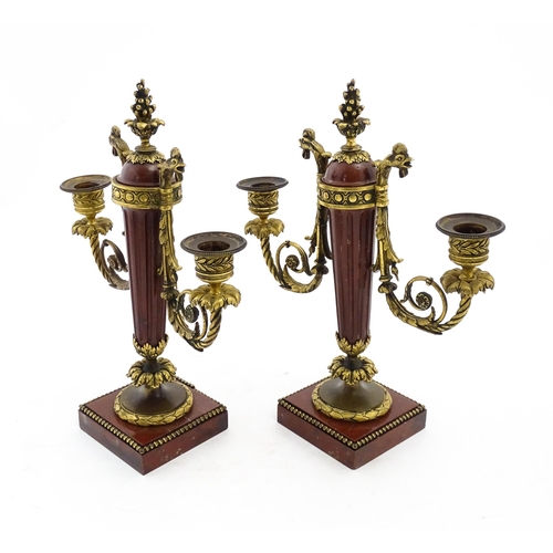 1264 - A pair of Continental 19thC marble and gilt metal twin branch candelabra / garnitures, the scrolling... 