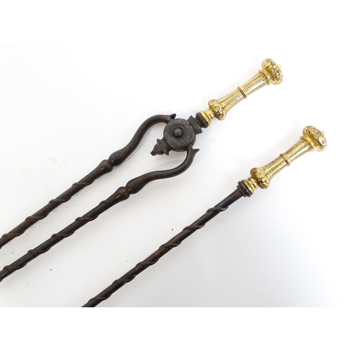 1269 - Two 20thC cast fire tools with twist detail comprising tongs and shovel. Tongs approx. 30