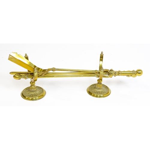 1270 - A 20thC brass fireside companion set comprising a pair of shaped stands, poker, tongs and shovel. Fi... 