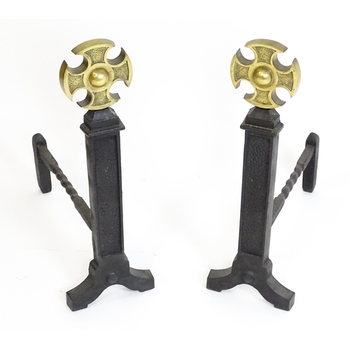 1271 - A pair of 20thC cast iron fire dogs surmounted by brass crosses. Approx. 21 1/2