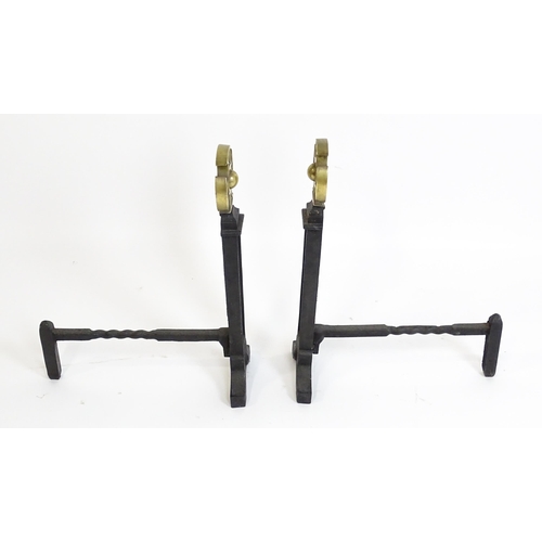 1271 - A pair of 20thC cast iron fire dogs surmounted by brass crosses. Approx. 21 1/2