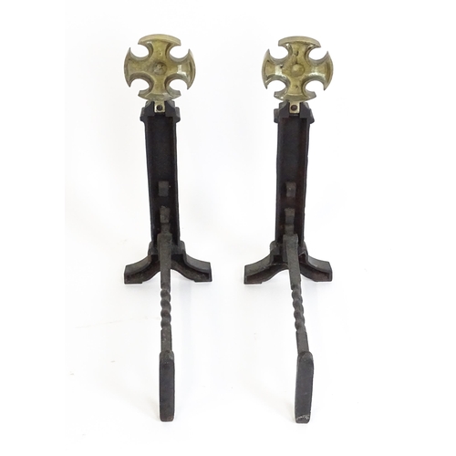 1271 - A pair of 20thC cast iron fire dogs surmounted by brass crosses. Approx. 21 1/2