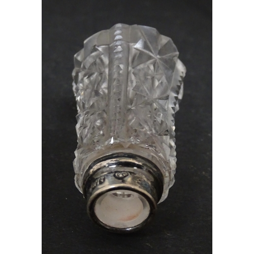 255 - A cut glass vase with silver rim hallmarked London 1920. Together with a scent bottle with silver ri... 