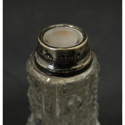 255 - A cut glass vase with silver rim hallmarked London 1920. Together with a scent bottle with silver ri... 