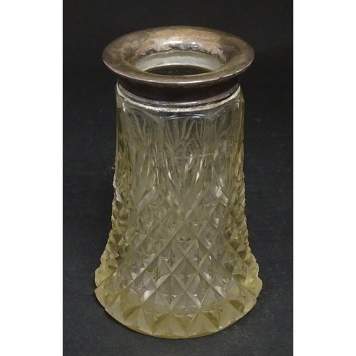 255 - A cut glass vase with silver rim hallmarked London 1920. Together with a scent bottle with silver ri... 