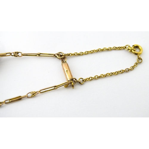 670 - A yellow metal necklace set with 15 Japanese ojime beads, with various decoration to include floral ... 