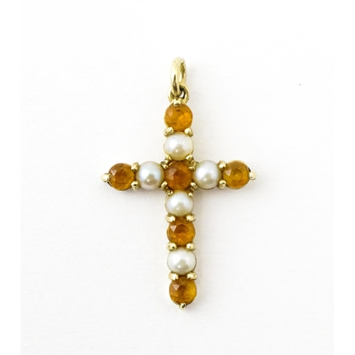 672 - A 9ct gold pendant of cross form set with citrine and seed pearls. Approx. 1