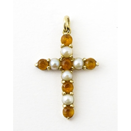 672 - A 9ct gold pendant of cross form set with citrine and seed pearls. Approx. 1