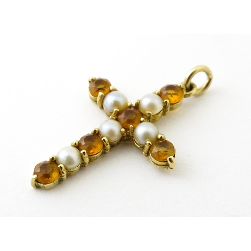 672 - A 9ct gold pendant of cross form set with citrine and seed pearls. Approx. 1