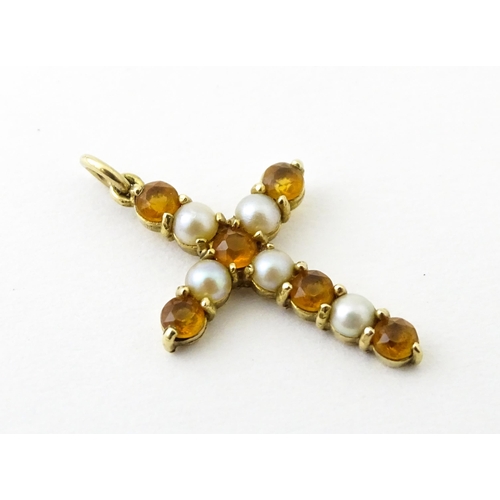 672 - A 9ct gold pendant of cross form set with citrine and seed pearls. Approx. 1