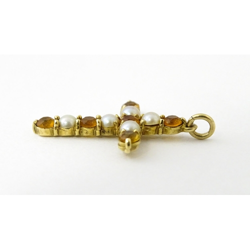 672 - A 9ct gold pendant of cross form set with citrine and seed pearls. Approx. 1