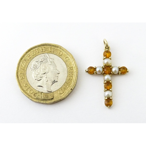 672 - A 9ct gold pendant of cross form set with citrine and seed pearls. Approx. 1