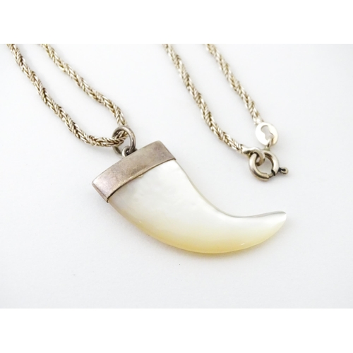 676 - A silver necklace with mother of pearl and silver mounted pendant of tiger claw form. Pendant approx... 