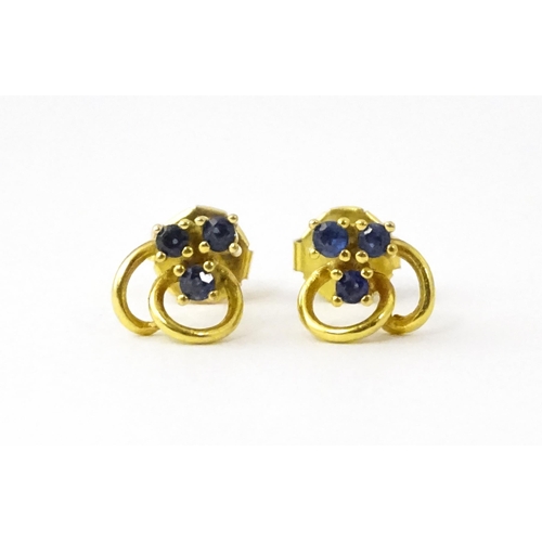 678 - A pair of 9ct gold stud earrings set with blue stones