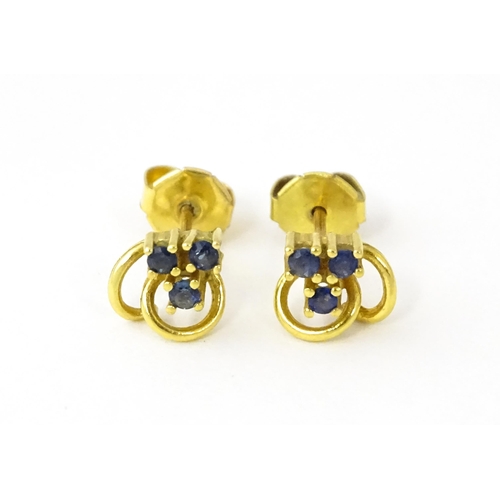 678 - A pair of 9ct gold stud earrings set with blue stones