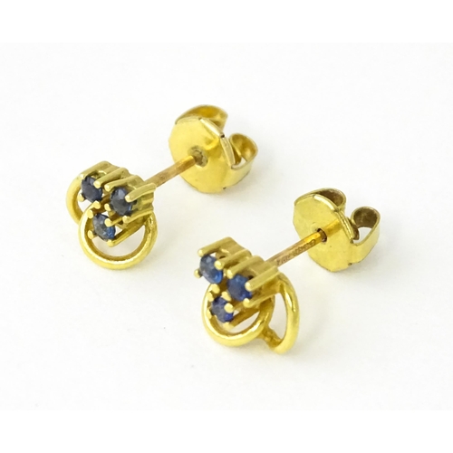 678 - A pair of 9ct gold stud earrings set with blue stones