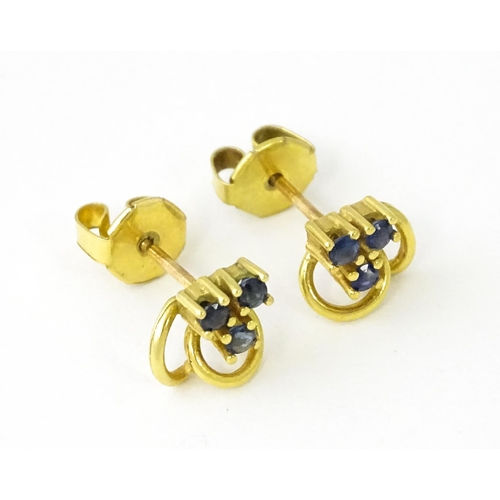 678 - A pair of 9ct gold stud earrings set with blue stones