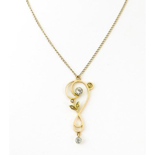 682 - A 15ct gold pendant set with aquamarines and seed pearls, on a 9ct gold chain. Pendant approx. 1 1/2... 