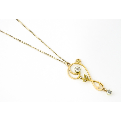 682 - A 15ct gold pendant set with aquamarines and seed pearls, on a 9ct gold chain. Pendant approx. 1 1/2... 