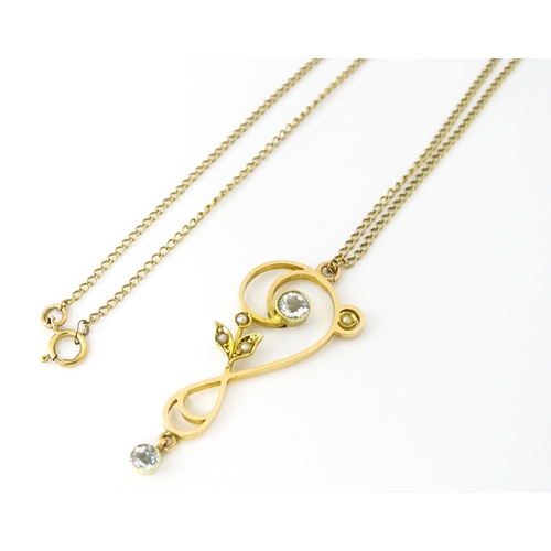 682 - A 15ct gold pendant set with aquamarines and seed pearls, on a 9ct gold chain. Pendant approx. 1 1/2... 