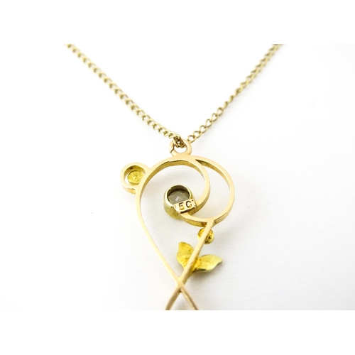 682 - A 15ct gold pendant set with aquamarines and seed pearls, on a 9ct gold chain. Pendant approx. 1 1/2... 