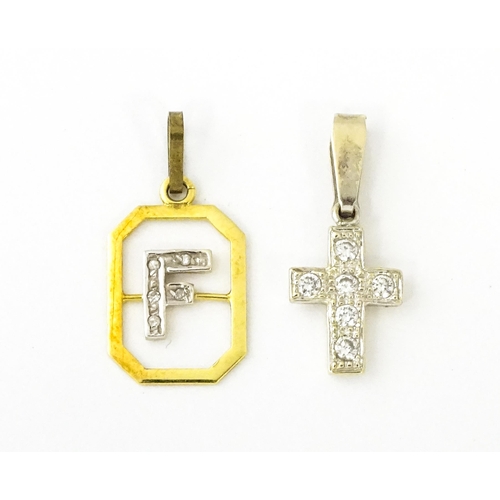 683 - An 18ct gold pendant with letter F to centre having diamond detail. Together with a cross form penda... 