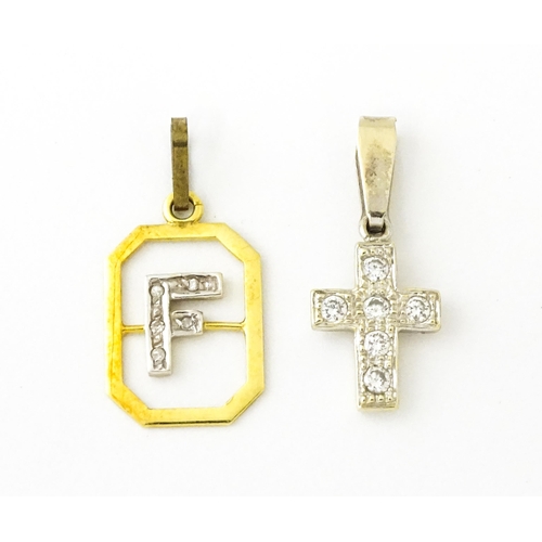 683 - An 18ct gold pendant with letter F to centre having diamond detail. Together with a cross form penda... 