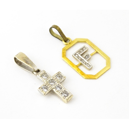 683 - An 18ct gold pendant with letter F to centre having diamond detail. Together with a cross form penda... 