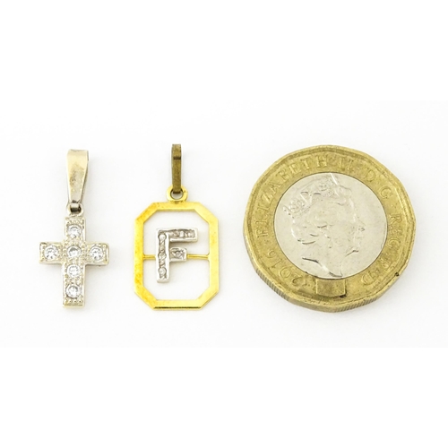 683 - An 18ct gold pendant with letter F to centre having diamond detail. Together with a cross form penda... 