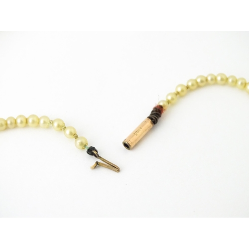 684 - A vintage necklace of graduated pearls with a 9ct gold clasp. Approx. 14